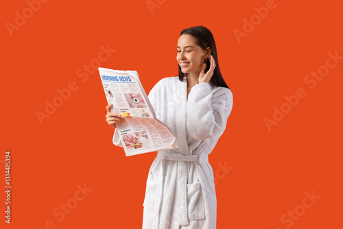 Young woman in bathrobe rea...