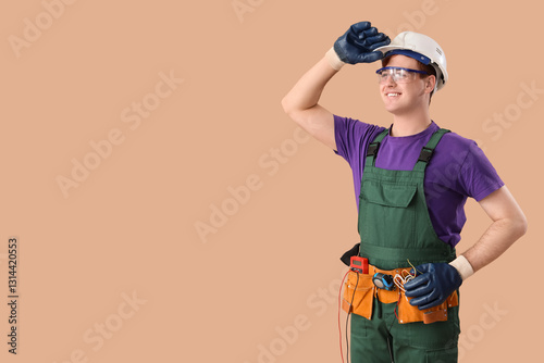 Male electrician on brown b...
