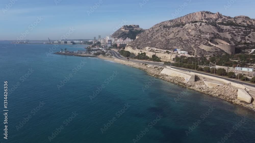 Aerial view of the coastal walk in the north of the city of Alicante. Sangueta mount and Santa Barbara castle in the background. Aerial view of the coastal walk in the north of the city of Alicante. Sangueta mount and Santa Barbara castle in the background.