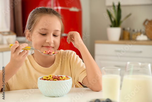 Cute little girl eating cer...