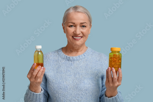 Mature woman with bottle of...
