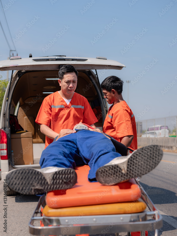 Two paramedics in orange uniforms rushing to provide urgent medical care and transport