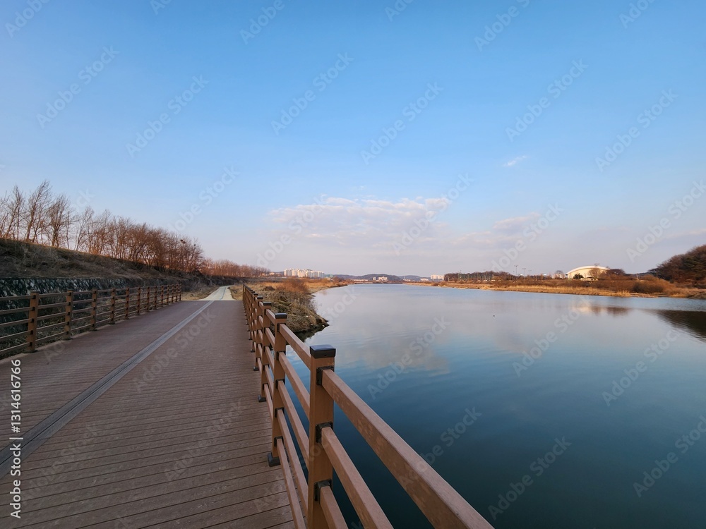 Naklejka premium picturesque bike path along the river.