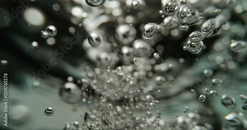 Slow motion shot of boiling water. Bubbles of boiling water background. Cooking concept