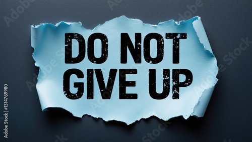 A ripped piece of paper displaying the words Do Not Give Up.