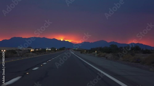 Driving on a road to Yuma, Arizona with a vibrant sunset in slow motion 120fps