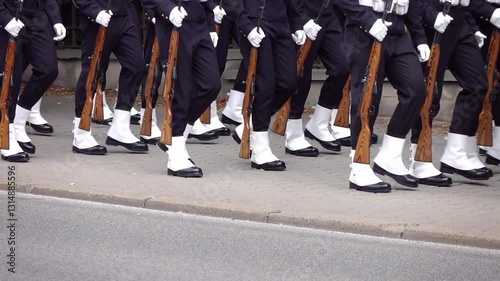 Navy soldiers marching on a sidewalk during a parade in slow motion 120fps