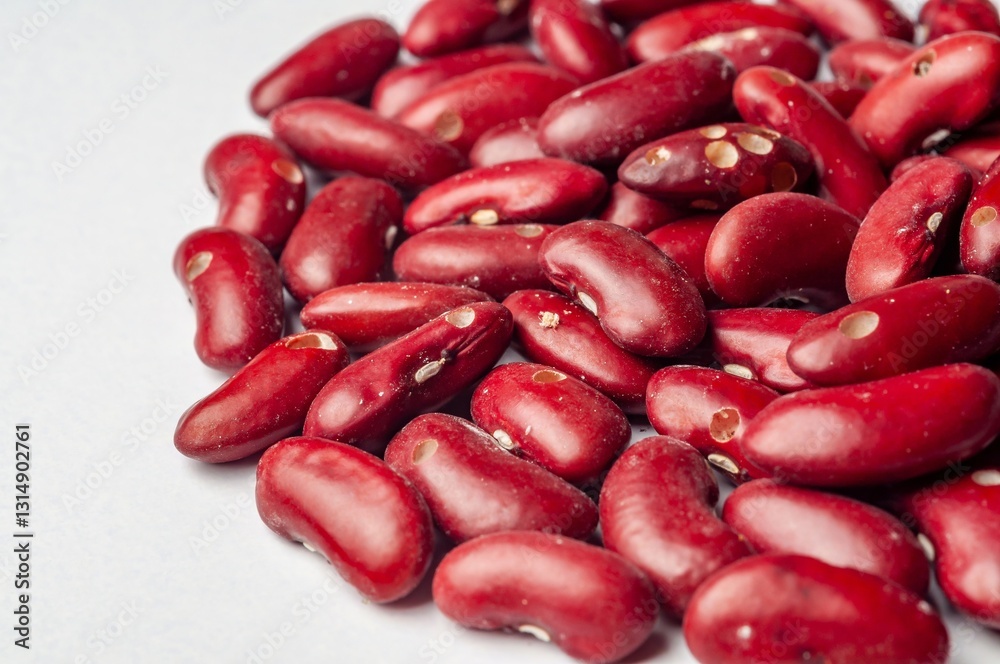 A close-up studio shot showcases the vibrant color and texture of raw red kidney beans. A close-up studio shot showcases the vibrant color and texture of raw red kidney beans.
