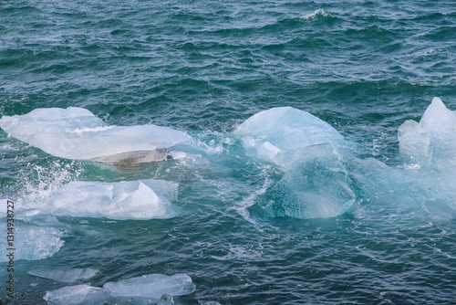 Icebergs floating on jokulsarlon glacier lagoon in iceland photo