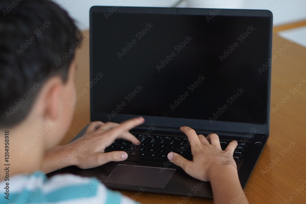 teenage boy typing on laptop with black screen perfect for mockup or copy space teenage boy typing on laptop with black screen perfect for mockup or copy space