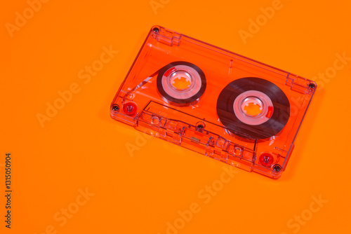 Retro audio cassettes on orange background