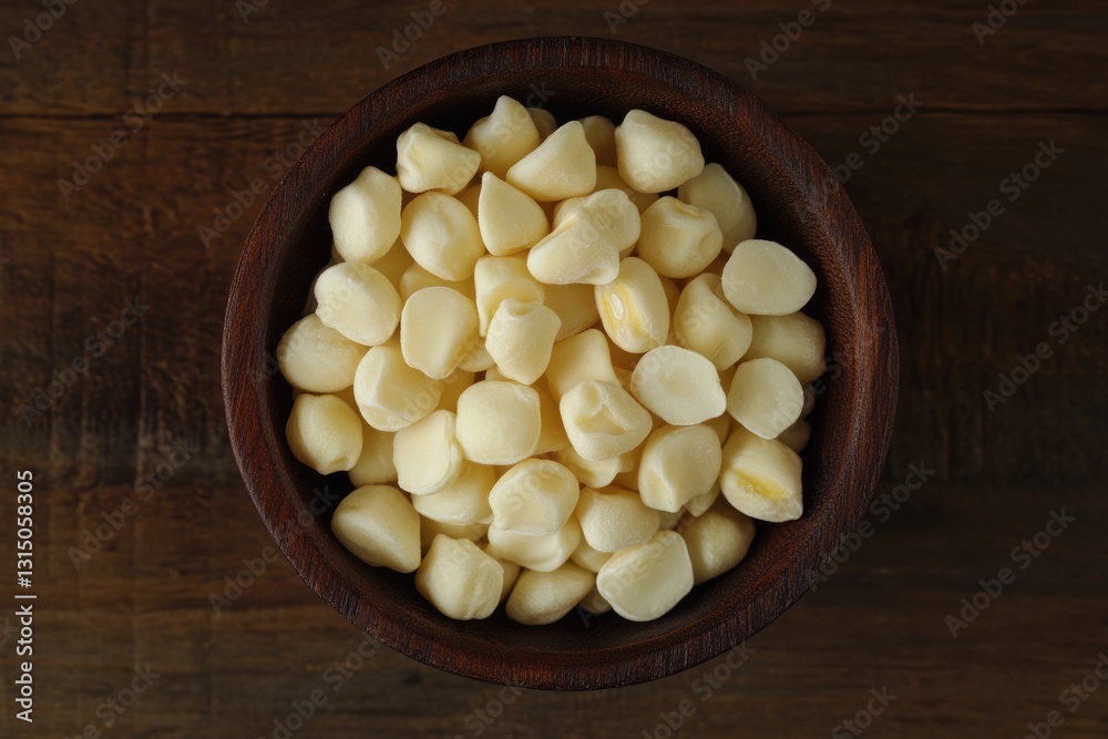 White Butter Beans in a Rustic Wooden Bowl on Dark Brown Wood Surface - Top View Close-Up Image White Butter Beans in a Rustic Wooden Bowl on Dark Brown Wood Surface - Top View Close-Up Image