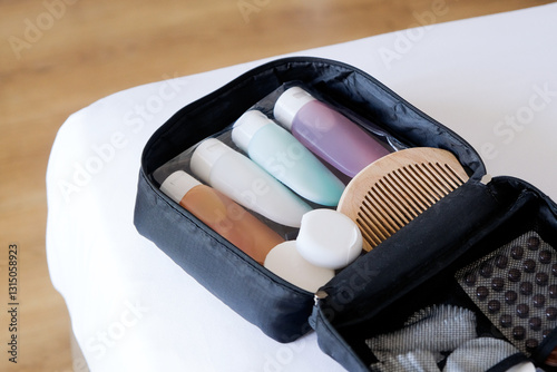 Cosmetic travel kit on the bed. colorful cosmetic bottles packed in plastic bag