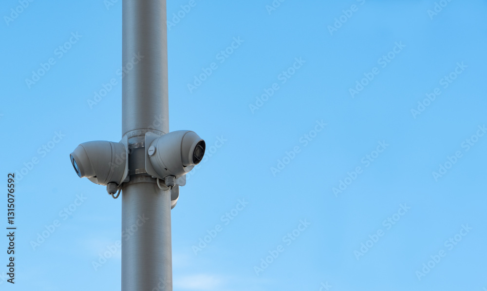 Surveillance cameras on a pole facing in different directions Surveillance cameras on a pole facing in different directions