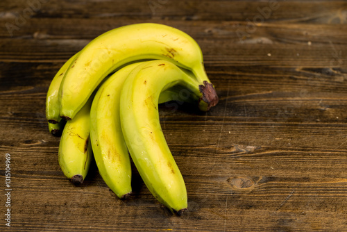 a ripe banana with a yellow-green peel is on the table