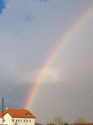 Nupaky, Czech republic - May 17, 2021. Double rainbow of cumulonimbus with blue sky in background photo