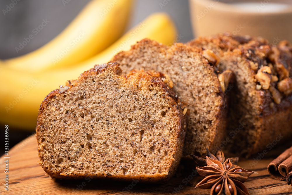 Φωτογραφία Banana bread with cinnamon and walnuts on wooden board, texture of vegan banana