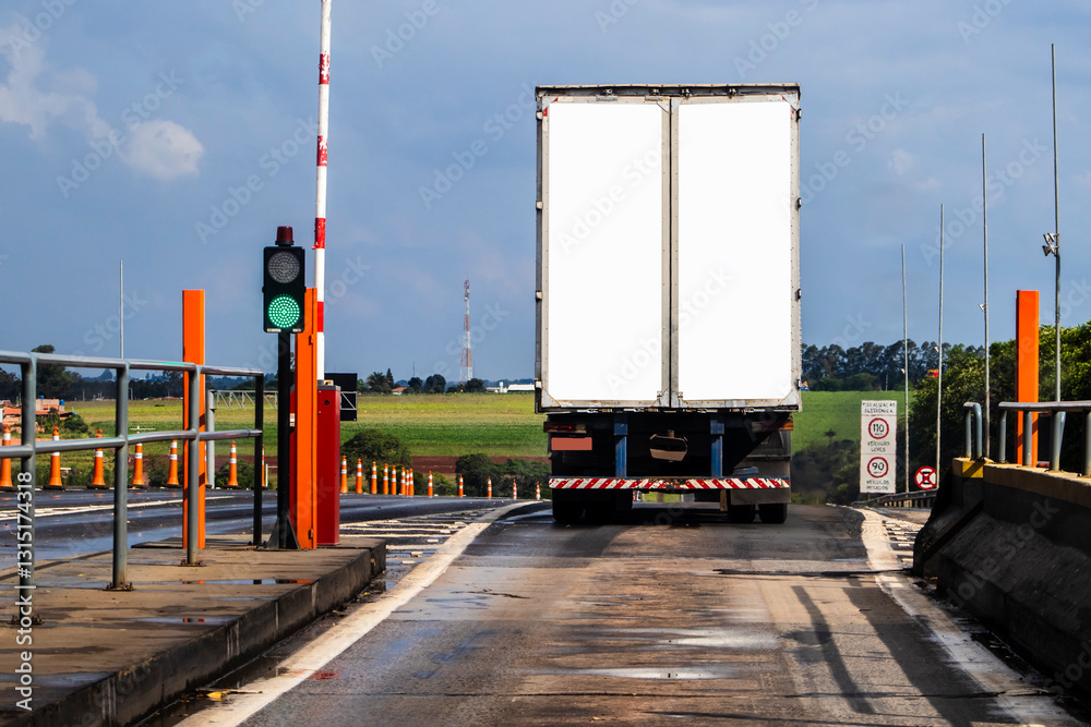 White truck and container is on the pay toll checkpoint. Toll booths at highway in Brazil. business, commercial, cargo transportation concept, clear and blank space on the rear view