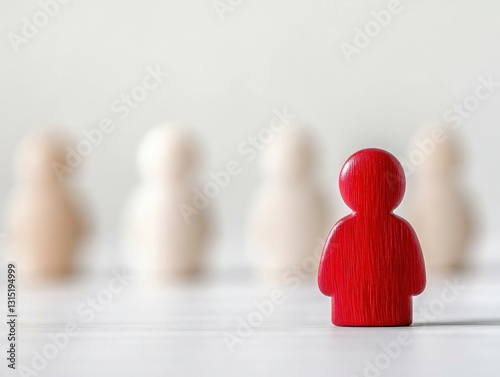 A red wooden figure standing out in front of a group of white figures symbolizing employee retention strategies