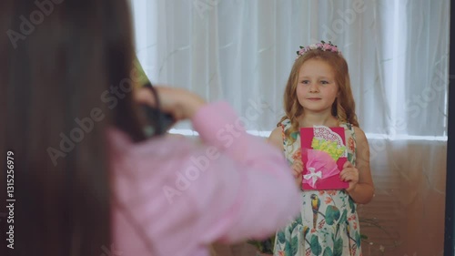 A girl with a gift at a matinee on March 8, on March 8 in kindergarten, a girl with a postcard on March 8