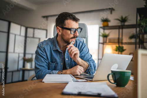 focused concentrated man work on laptop from home office