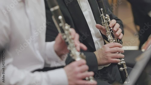 Musician playing clarinet in orchestra rehearsal