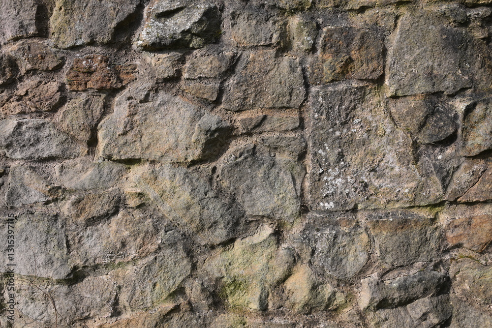 A wall made of stone with a rough texture