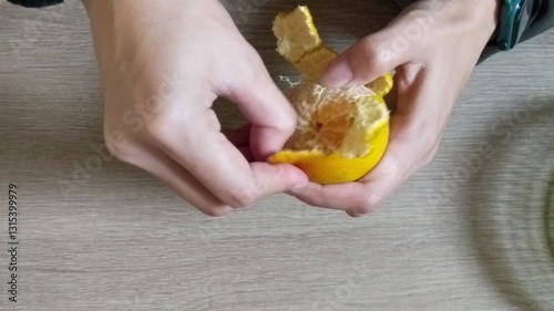 Peeling Orange Fruit Closeup - Person Removing Peel from Fresh Orange