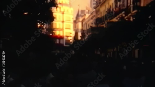 A crowd of people are walking down a street at dusk. Vintage 60