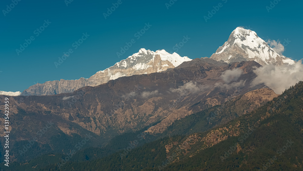 GHOREPANI, NEPAL - JANUARY 9, 2025: Beautiful views over the majestic mountains in Ghorepani, Nepal, nature unfolds its beauty in this serene location. GHOREPANI, NEPAL - JANUARY 9, 2025: Beautiful views over the majestic mountains in Ghorepani, Nepal, nature unfolds its beauty in this serene location.