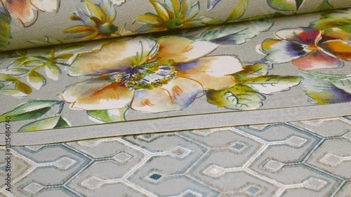 Catalog of wallpaper samples for walls in close-up. Wallpaper store. The concept of design and renovation of the house. The choice of decorative coatings.