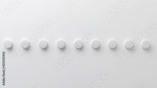Minimalist composition of white pills arranged in a neat row on a plain surface