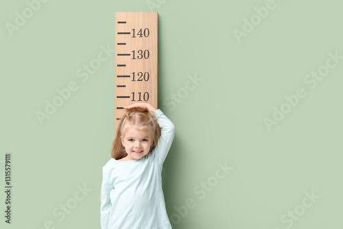 Cute little girl measuring ...