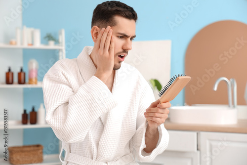 Shocked young man with hair...