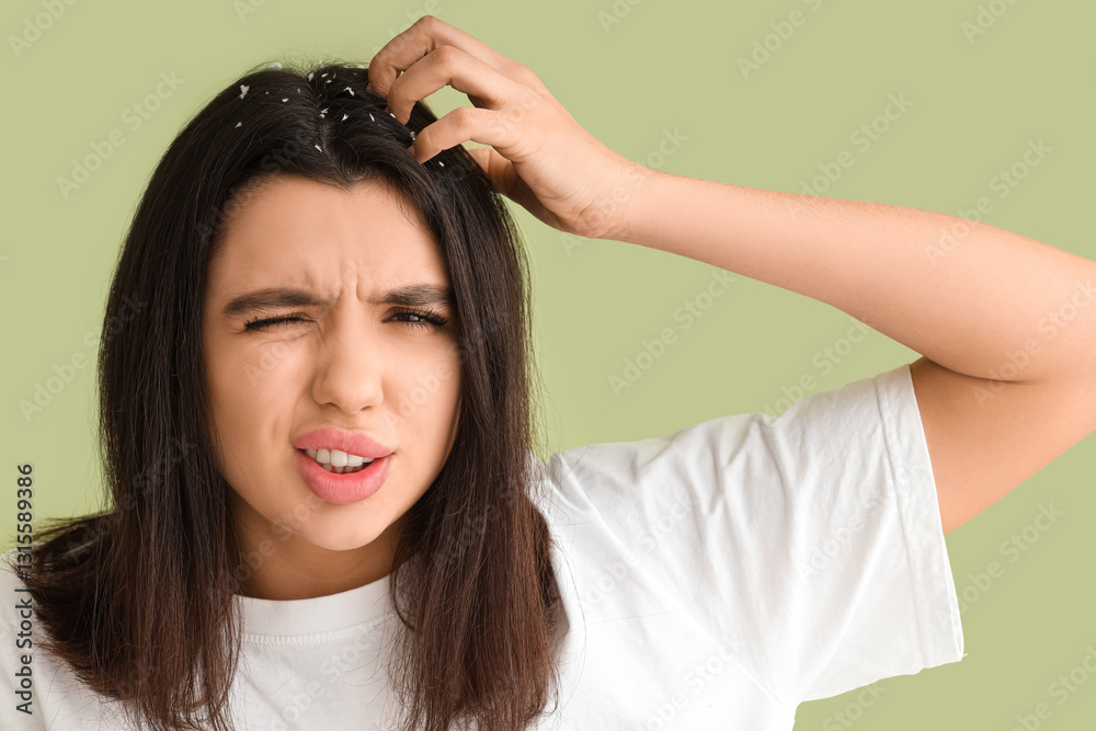 Fototapeta premium Young woman with dandruff problem scratching head on green background