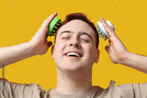 Young man using hair scalp ...