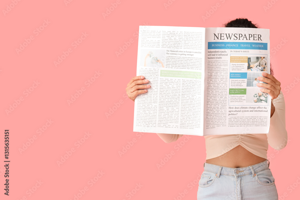 Naklejka premium Young African-American woman with newspaper on pink background
