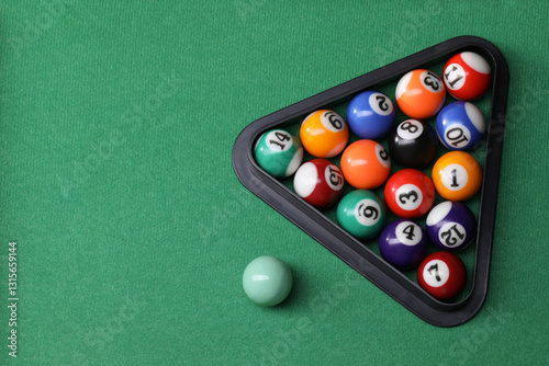 Billiard balls triangle rack on green table, top view. Space for text