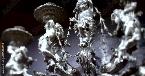 A slow pan reveals a chandelier in the Palma de Mallorca cathedral, highlighted by the selective focus of a tilt-shift lens