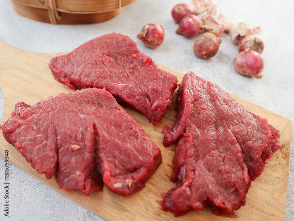 Fresh raw beef isolated on grey background. The feast of Qurban Ied al adha mubarak. food preparation Fresh raw beef isolated on grey background. The feast of Qurban Ied al adha mubarak. food preparation