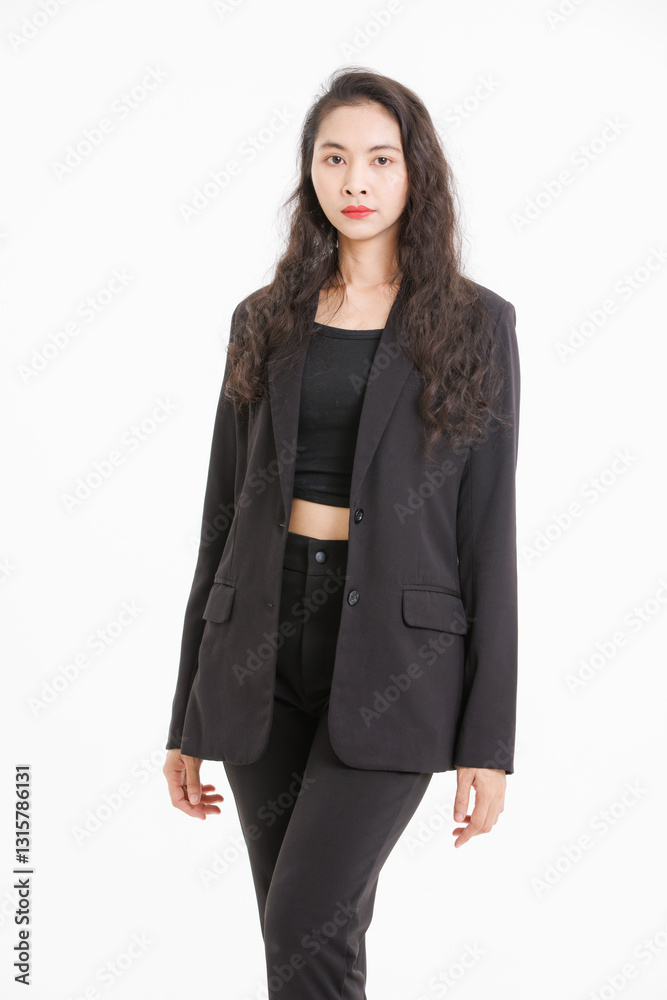 Portrait of asian beautiful woman curly long hair, wearing black suit, black long pants, model girl positive attractive confident charming, standing pose look at camera on white background in studio.