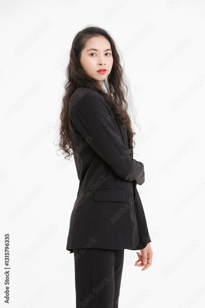 Portrait of asian beautiful woman curly long hair, wearing black suit, black long pants, model girl positive attractive confident charming, standing pose look at camera on white background in studio. Portrait of asian beautiful woman curly long hair, wearing black suit, black long pants, model girl positive attractive confident charming, standing pose look at camera on white background in studio.