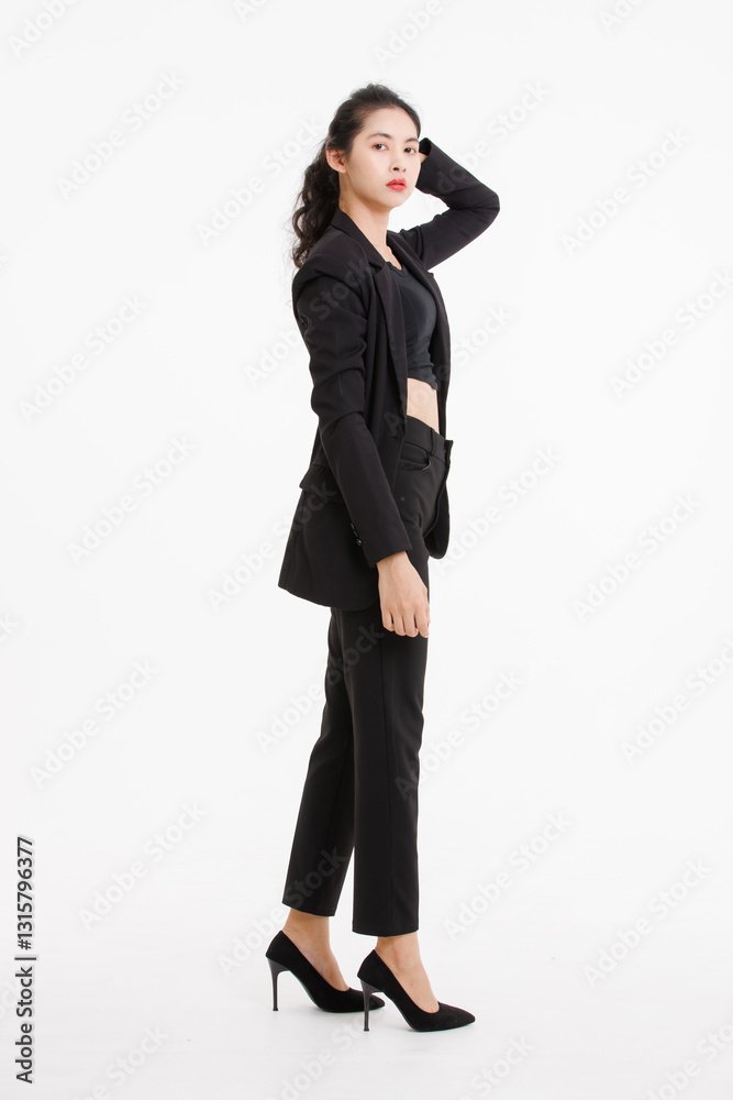 Portrait full body of asian beautiful woman curly long hair, wearing black suit, black long pants, model girl attractive confident charming, standing pose look at camera on white background in studio. Portrait full body of asian beautiful woman curly long hair, wearing black suit, black long pants, model girl attractive confident charming, standing pose look at camera on white background in studio.