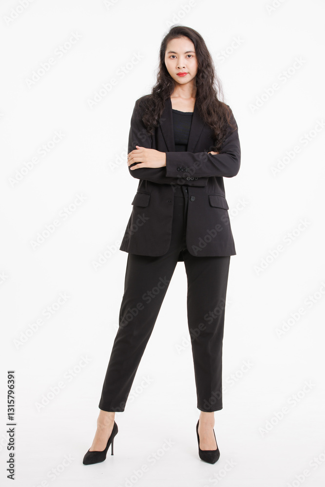Portrait full body of asian beautiful woman curly long hair, wearing black suit, black long pants, model girl attractive confident charming, standing pose look at camera on white background in studio. Portrait full body of asian beautiful woman curly long hair, wearing black suit, black long pants, model girl attractive confident charming, standing pose look at camera on white background in studio.