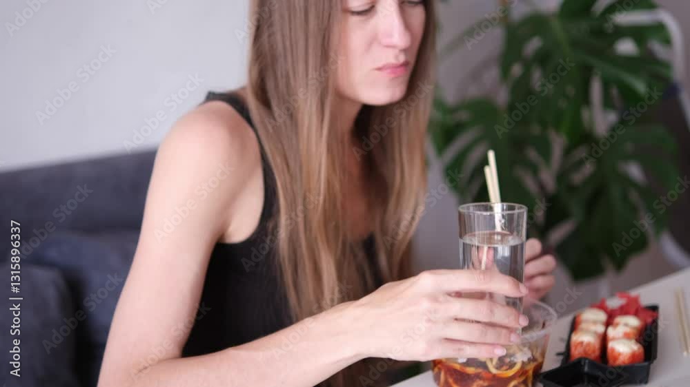 Young attractive woman enjoying asian food at home. Asian food concept. Part of series Young attractive woman enjoying asian food at home. Asian food concept. Part of series
