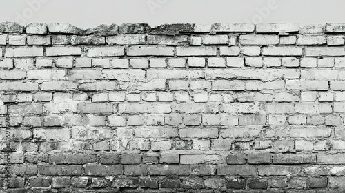 Weathered gray brick wall with chipped and broken surface