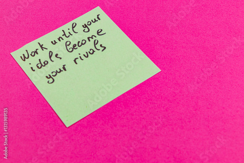 Motivational note on a bright pink background encouraging hard work