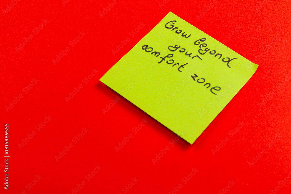 Sticky note encouraging personal growth on a vibrant red background Sticky note encouraging personal growth on a vibrant red background