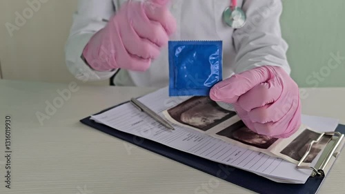 Doctor holding condoms in his hands 