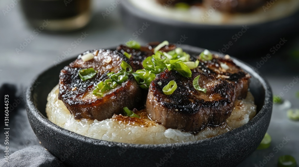 A close-up of a rice flour cake topped with grilled pork and scallions. A close-up of a rice flour cake topped with grilled pork and scallions.